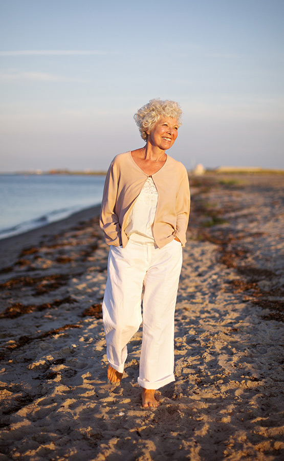 portrait of senior woman walking on the beach retiremetn planning tools melbourne fl